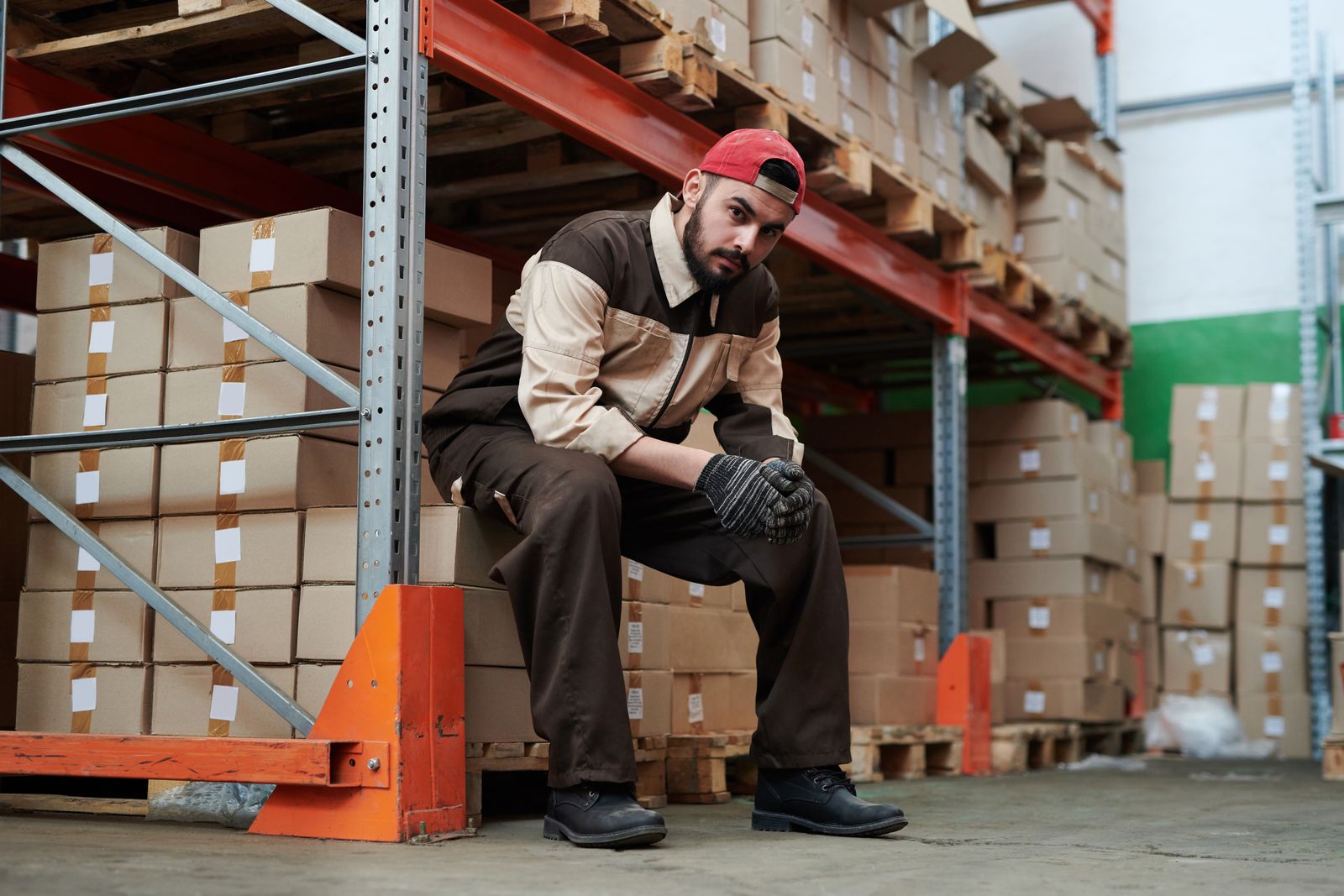 Warehouse worker with pallet of boxes at the depot
