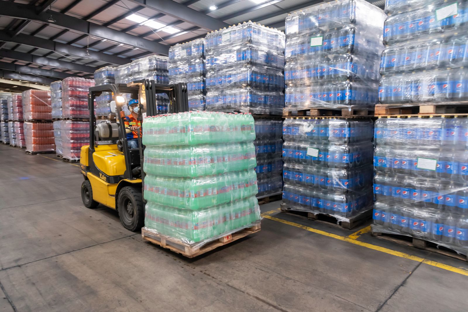 Forklift operating inside a logistics warehouse